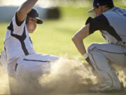 Brayden Maney, left, of Skyview High School is tagged out by Jaden Sawyer of Todd Beamer High School .