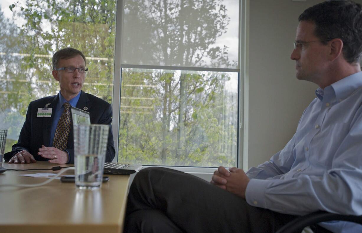 Republican candidate for governor Rob McKenna, left, talks with nLight President and CEO Scott Keeney on Monday about the company's program that helps prepare students for high-demand fields that require expertise in math, science, engineering and technology.