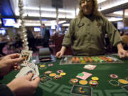 Colleen Thompson deals a Pai Gow player four kings Feb. 9 at the Oak Tree Casino in Woodland.