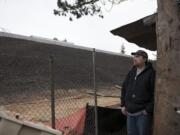 Steven Hoard of Vancouver looks up at the hillside between his backyard and the southbound lanes of Interstate 205. The hillside used to be full of trees, bushes and other brush that muffled the freeway sounds and stabilized the slope, but the state cleared the area to make way for interchange improvements.