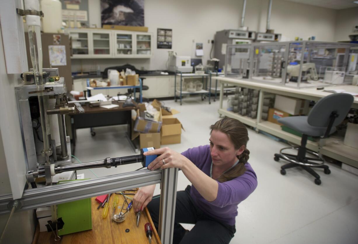 Physical science technician Kate Norton prepares to photograph a sediment sample Tuesday. Norton is studying how asbestos levels in the Sumas River in northern Washington and British Columbia affect movement of sediment through the river. The Cascades Volcano Observatory has one of eight sediment labs in the United States. Although the 1980 Mount St.