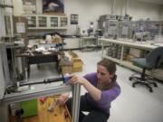 Physical science technician Kate Norton prepares to photograph a sediment sample Tuesday. Norton is studying how asbestos levels in the Sumas River in northern Washington and British Columbia affect movement of sediment through the river. The Cascades Volcano Observatory has one of eight sediment labs in the United States. Although the 1980 Mount St.