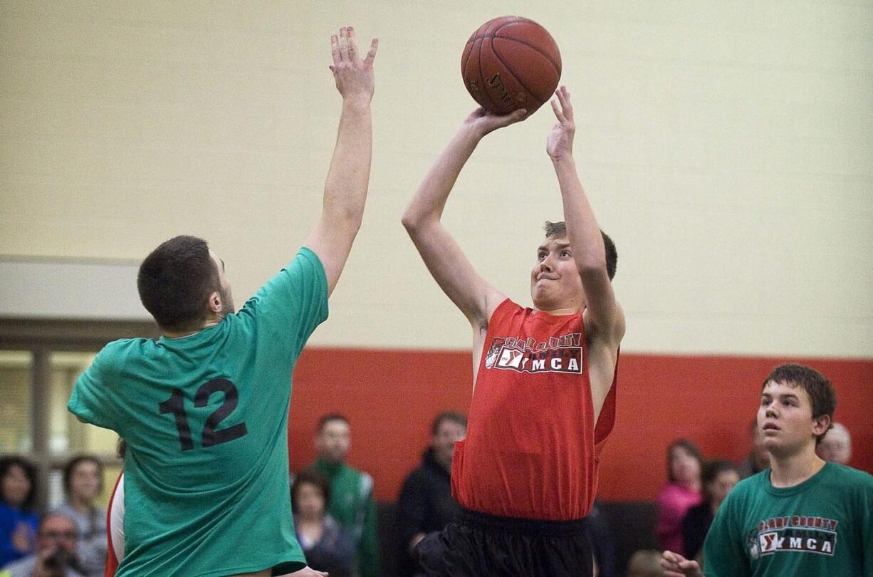 Matthew Pozsgai, 17, who has cystic fibrosis, puts up a shot in a YMCA recreational league.