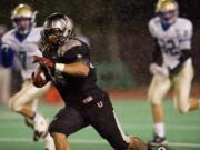 Union's Brandon Brody-Heim runs away from Tahoma defenders in the first half at McKenzie Stadium, Friday, November 4, 2011.