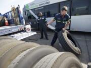 Photos by Steven Lane/The Columbian
Superior Tire Service workers Shawn Paulus, right, and Kapaya Goodson replace faulty tires on a C-Tran bus this week. The agency raced to replace hundreds of tires recently recalled by Michelin.