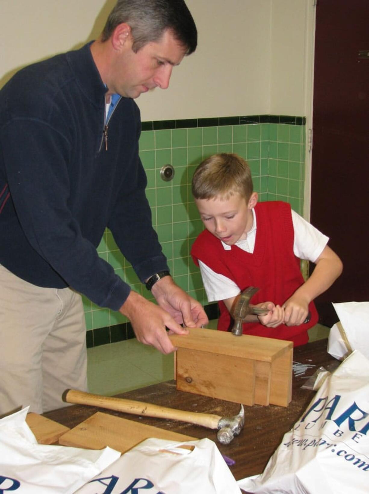 Evergreen Highlands: Chris Wall, left, helps his son Michael build a bat house during &quot;Bat Tuesday&quot; at St.