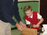 Evergreen Highlands: Chris Wall, left, helps his son Michael build a bat house during &quot;Bat Tuesday&quot; at St.