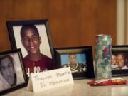 Zachary Kaufman/The Columbian
A bag of Skittles candy and a can of Arizona Ice Tea sit next to photographs of Trayvon Martin during a candlelight vigil at First Congregational United Church of Christ.