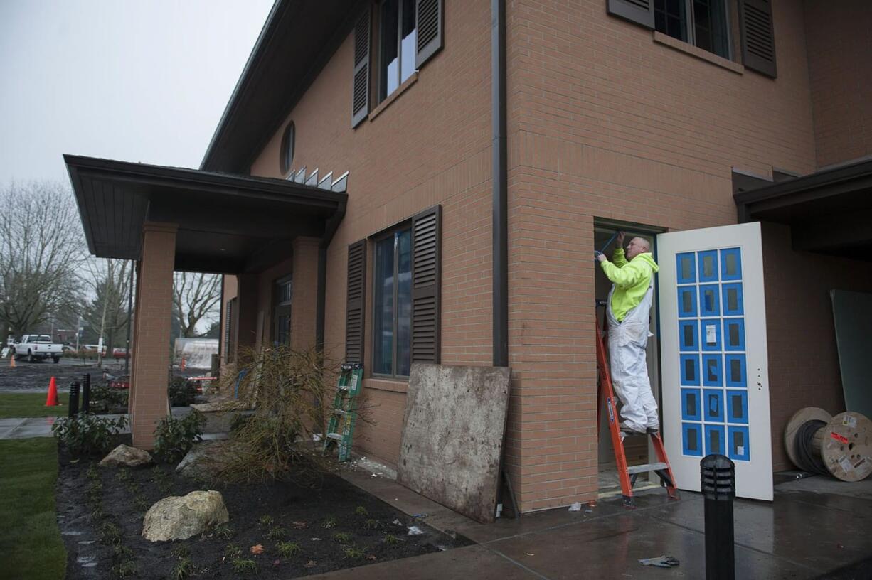 Jeff Wickline prepares a doorway area for painting Tuesday morning at the Fisher House. He works for Sabelhaus West Inc., a painting contractor based in Silverdale.