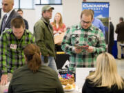 Army veterans Bryce Sanman, 24, left, and Richard Sheldon, 23, talk about job opportunities at OMSI at Thursday's job fair. Sanman and Sheldon served in Iraq together.