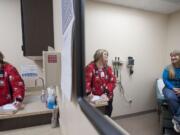 Photos by Zachary Kaufman/The Columbian
Medical assistant Lisa Wood, left, takes information from patient Barbara Kelly of Vancouver during a routine follow-up visit to Columbia River Occupational Health.