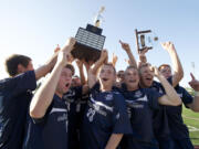 The Skyview High School boys soccer team hoist the 4A State Soccer Championship trophy Saturday May 26, 2012 at Carl Sparks Stadium in Puyallup, Washington.