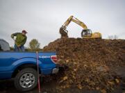 Brian Galbreth of the Ellsworth neighborhood dumps his fourth and final truckload of leaves at H&amp;H Wood Recyclers on Sunday. Galbreth said the free program allowed him to dispose of perhaps 1,500 pounds of leaves.