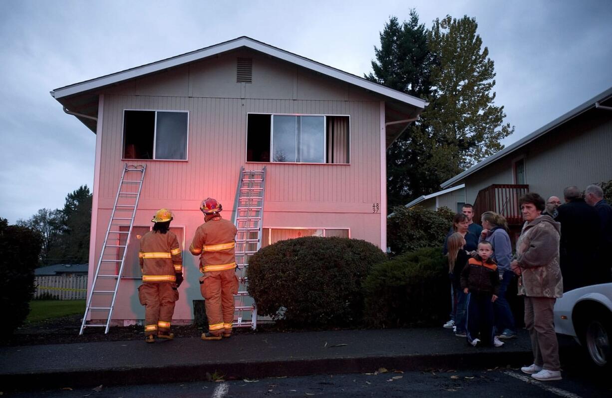 Firefighters investigate a fatal fire at 2900 H St.