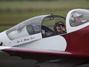 Jule Sugnet, 10, of Portland, waves to her mother and brother as Tom Sampson taxis his experimental home-built RV-7 airplane after taking the youngster for a ride during Pearson Air Museum's Open Cockpit Day on Saturday.