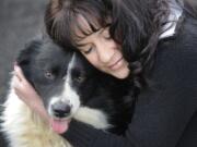 Dea Taylor-West hugs Ben, a dog she helped rescue Tuesday, outside the West Columbia Gorge Humane Society in Washougal. The woman's neighbor, Steven Stanbary, owned Ben before killing himself and two other people Dec.