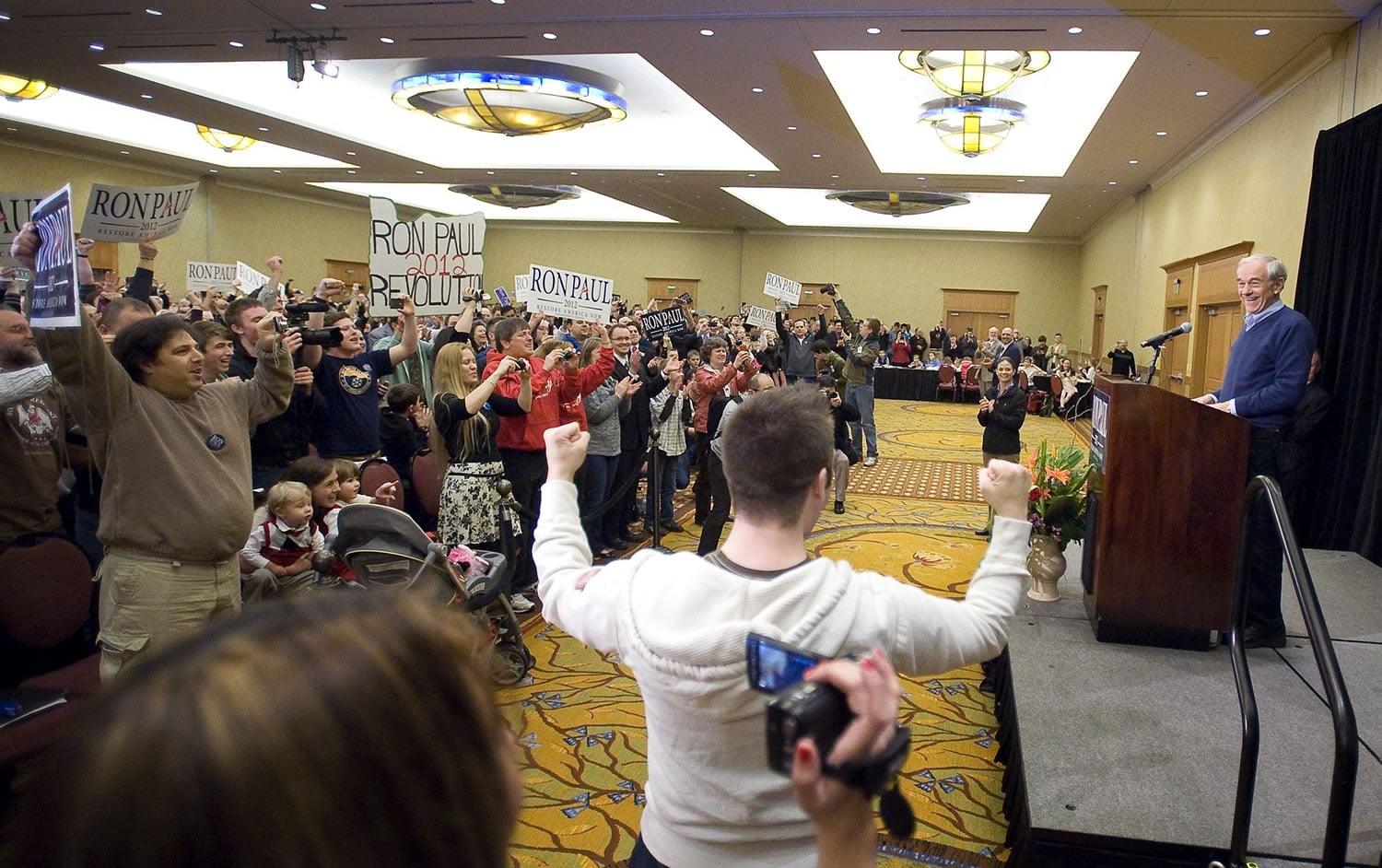 Republican presidential candidate Ron Paul takes the stage during a rally at the Hilton Vancouver Washington on Thursday. The crowd waved signs and chanted &quot;President Paul&quot; to show their support.