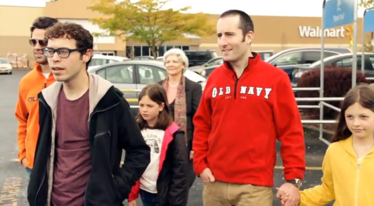 A group in a Walmart parking lot sings &quot;The Dream of the Suburbs is Alive in Vancouver&quot; in a scene from &quot;Vancouvria.&quot;