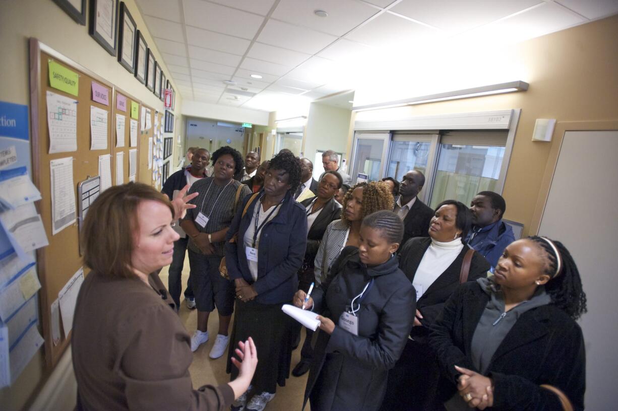 Charge Nurse Sandra Welker, left, leads a delegation of civic, health and government officials from the Republic of Botswana on a tour of Legacy Salmon Creek Medical Center's intensive-care unit.