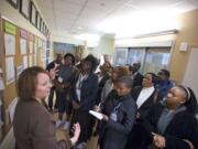 Charge Nurse Sandra Welker, left, leads a delegation of civic, health and government officials from the Republic of Botswana on a tour of Legacy Salmon Creek Medical Center's intensive-care unit.