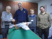 Hudson's Bay: Pearson Air Museum volunteer John Kalde, left, shakes hands with George Humphries, who loaned the museum a fighter plane model for the new Tuskegee Airmen display.