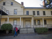 Historical architect and consultant Fred Walters walks past an East Barracks building Monday.