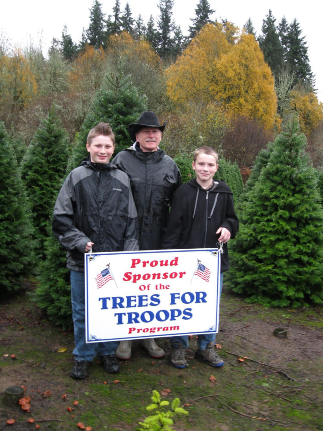 La Center: Daniel Boynton, from left, Stephen Boynton and John Boynton of La Center Farms donate Christmas trees to Trees for Troops.