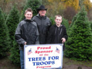 La Center: Daniel Boynton, from left, Stephen Boynton and John Boynton of La Center Farms donate Christmas trees to Trees for Troops.