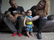 Randi King and her fiance, Cornell Collins, play with their baby, Mason, 8 months, at their downtown Vancouver home.