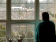 Renee Anttila looks out on the gravel quarry behind her First Place Neighborhood home on Tuesday. The quarry, owned by Tapani Underground, will be mined out by the end of the year and then reclaimed.