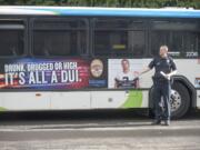 Lt. Steve Neal talks about an ad warning people not to drive drunk or high, as seen on the side of a C-Tran bus Thursday. The Vancouver Police Department received a $150,000 grant, most of which will go to extra patrols, from the state to combat impaired driving.