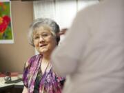 Steven Lane/The Columbian
Carole Axford, a secretary at the Clark County Prosecutor's Office, chats Wednesday with Deputy Prosecutor Michael Dodds. After 50 years, Axford is the longest-serving county employee in recent memory.