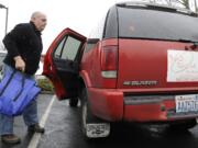 Topher Welborn, a driver and salesman for 360 Takeout, carries a lunch delivery.