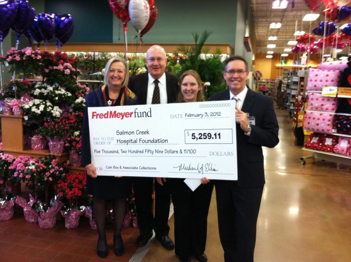 Salmon Creek: Diane Buelt of Legacy Salmon Creek Medical Center, from left; Bradley Carlson, chairman of the Salmon Creek Hospital Foundation board; Shashonee Thornton of Salmon Creek Fred Meyer; and Michael Schultz, executive director of Salmon Creek Hospital Foundation hold a check for Legacy's cancer fighting efforts.