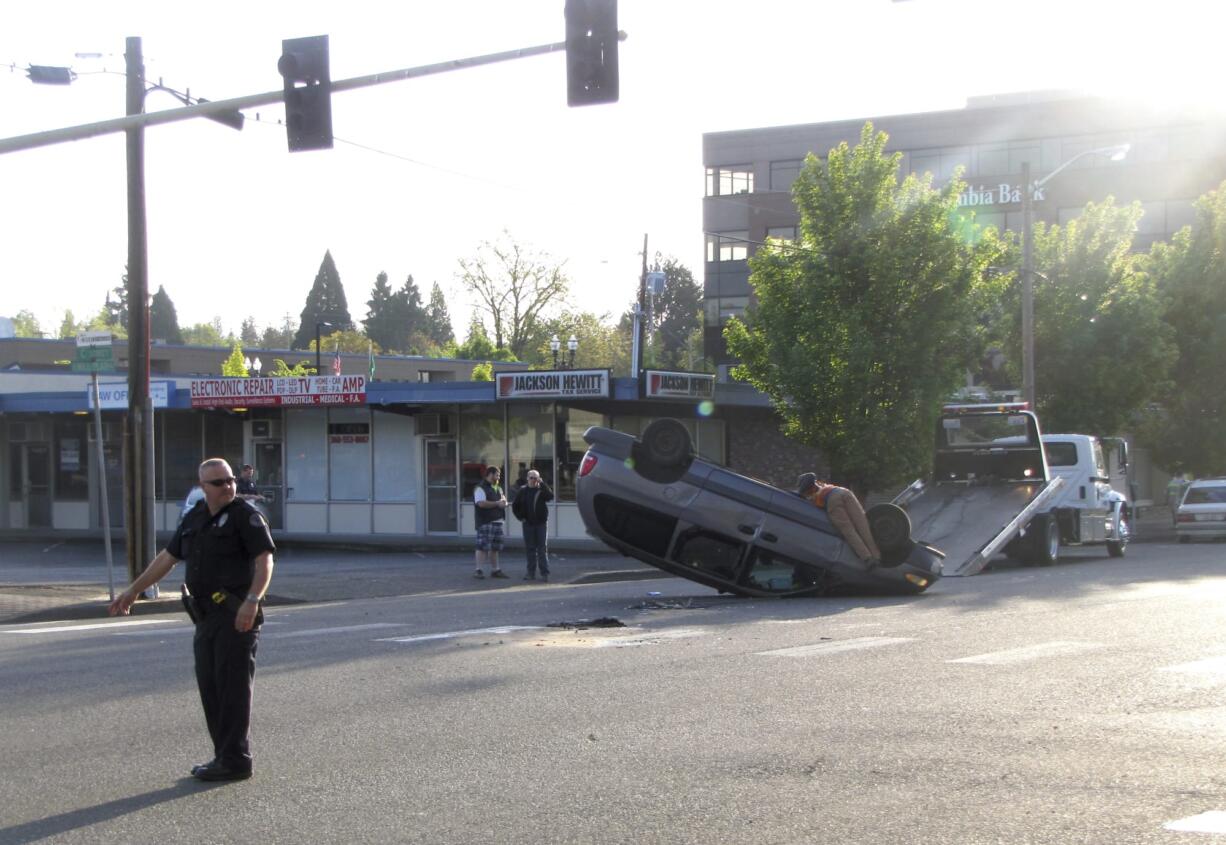 A flipped minivan blocked Tuesday morning traffic at Mill Plain Boulevard and C Street in downtown Vancouver.