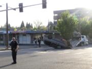 A flipped minivan blocked Tuesday morning traffic at Mill Plain Boulevard and C Street in downtown Vancouver.