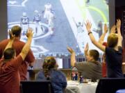 Photos by STEVEN LANE/The Columbian
Open House Ministries residents cheer for the Giants during the Super Bowl party at Christ Community Church in east Vancouver. The church put word out to shelters that residents were welcome.