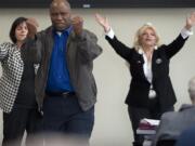 Rey Reynolds of Vancouver prays for the four corners of Clark County on Thursday at Vancouver City Hall.