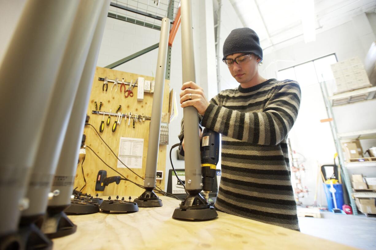 Employee Zach Thompson assembles a Gorilla Post.