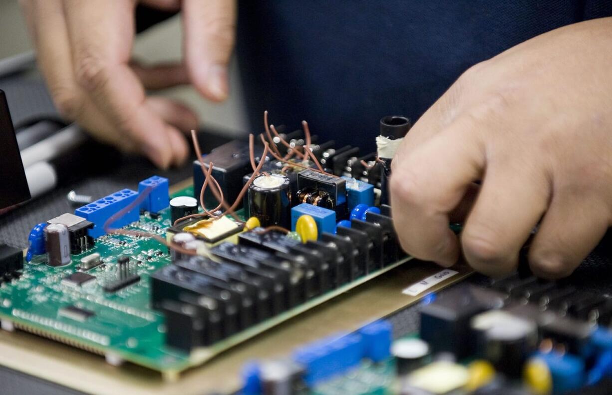 Wilson Manzano, lab tech at Underwriters Laboratories in Camas, tests components in a thermostat March 19.