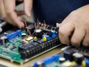 Wilson Manzano, lab tech at Underwriters Laboratories in Camas, tests components in a thermostat March 19.