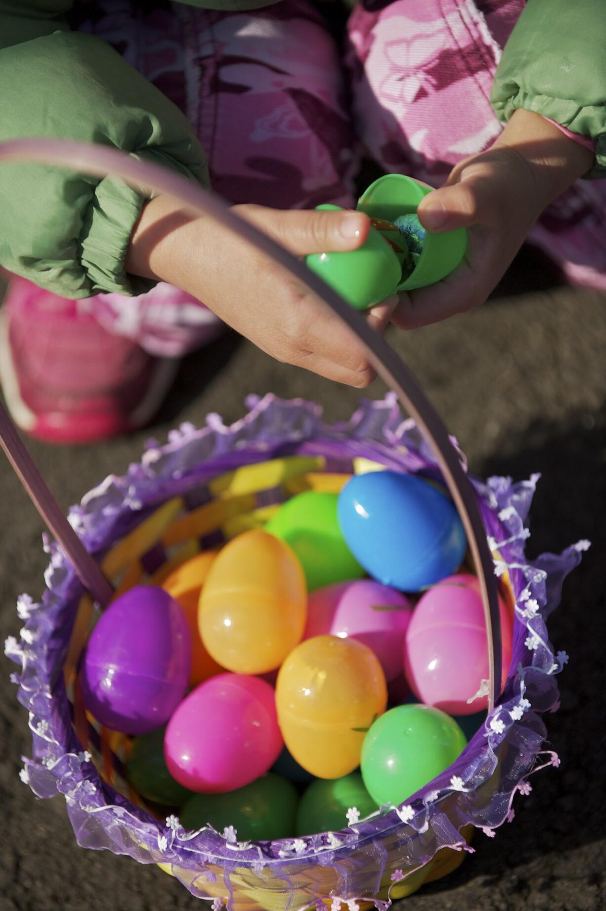 Sara Sanchez, 4, from Brush Prairie, cracks open  eggs during an Easter egg hunt at Kiwanis Park in Battle Ground, Saturday, April 7, 2012.