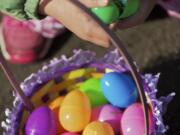 Sara Sanchez, 4, from Brush Prairie, cracks open  eggs during an Easter egg hunt at Kiwanis Park in Battle Ground, Saturday, April 7, 2012.