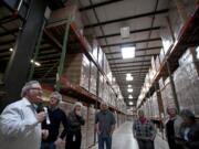 Tetra Pak Materials Factory Manager Robert Baker, left, leads Vancouver Mayor Tim Leavitt, second from left, and other officials on a tour Friday.