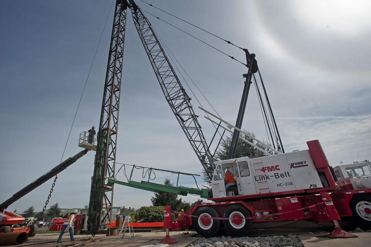 As part of the Columbia River Crossing, workers carry out pile driving and shaft drilling on the Oregon side of the river.