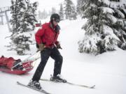 Clark County Superior Court Judge Scott Collier pulls a sled with a patient onboard while working ski patrol at Timberline Lodge in Oregon on March 31.