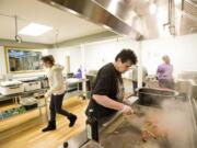 Photos by Steven Lane/The Columbian
Volunteer cook Violet Adams sautes vegetables in the brand new kitchen at The Lord's Gym in preparation for Feb. 10 hot meal service.