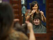 Lea Graves gives longtime client Tabi Evans a haircut at Vancouver's Essentials Day Spa &amp; Salon.