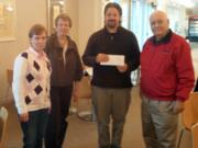 Glenwood: Winter Hospitality Overflow concert organizer Nancy Deibert, second from left, presents WHO coordinator Kevin Hiebert with a check for more than $9,400 as Darrell Brandenberg, right, and Peggy Kain look on.