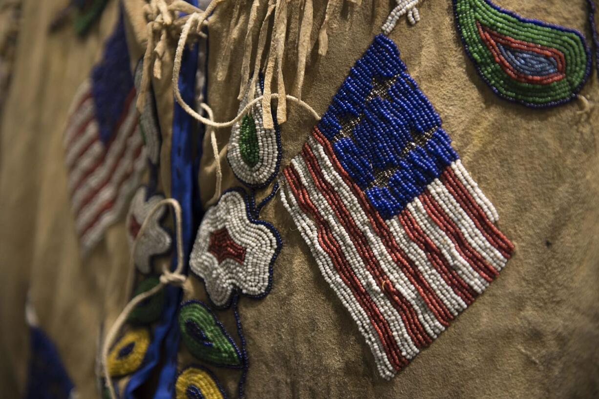 Detailed American flags are seen in beadwork on the exterior of a man&#039;s jacket from around the 1900&#039;s at the Clark County Historical Museum.